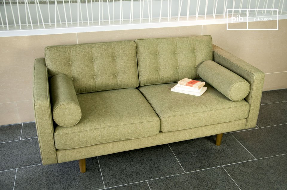 This sofa lays claim to a fifties look with its cylindrical armrests and compass legs