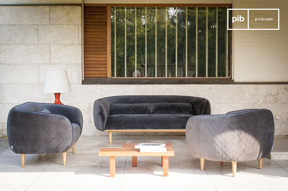 A grey velvet sofa with an original design