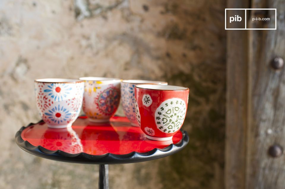 Four ceramic cups without handles with floral motifs.