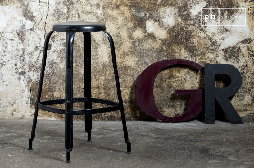 Large shiny black stool in industrial style.