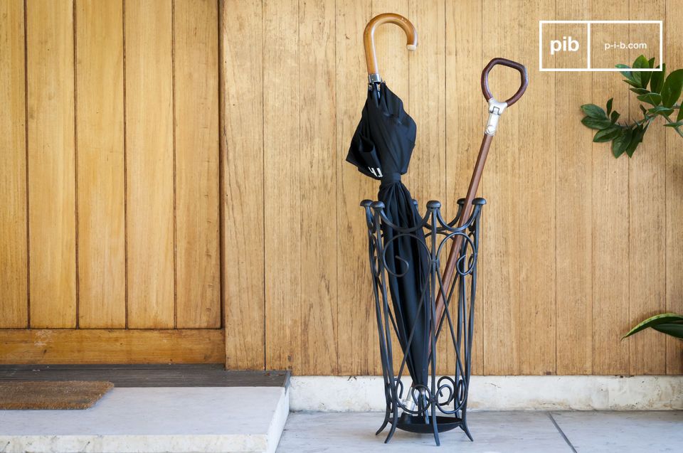 A vintage umbrella holder in black wrought iron.