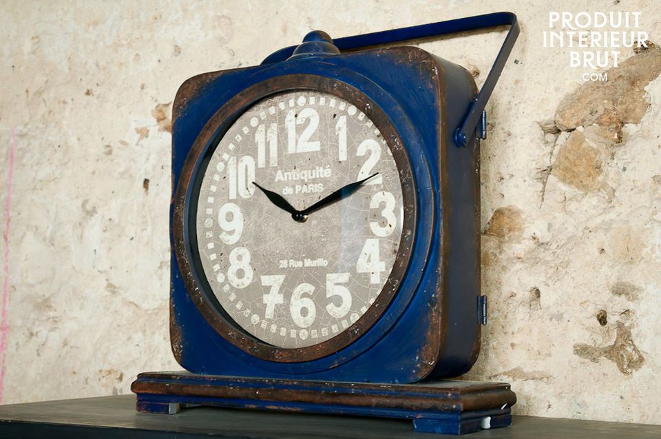 This free standing metal clock has a distressed dark blue finish that will give vintage style cachet