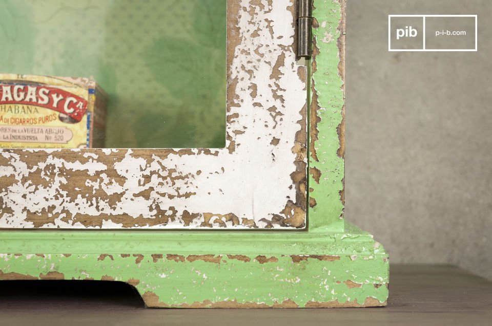 The floral pattern of the wallpaper back to these rustic shelves and its hand-distressed paint