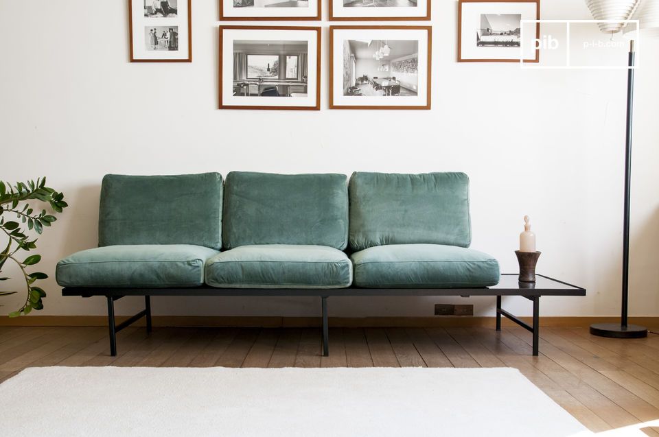 Beautiful green velvet sofa with a marble top.