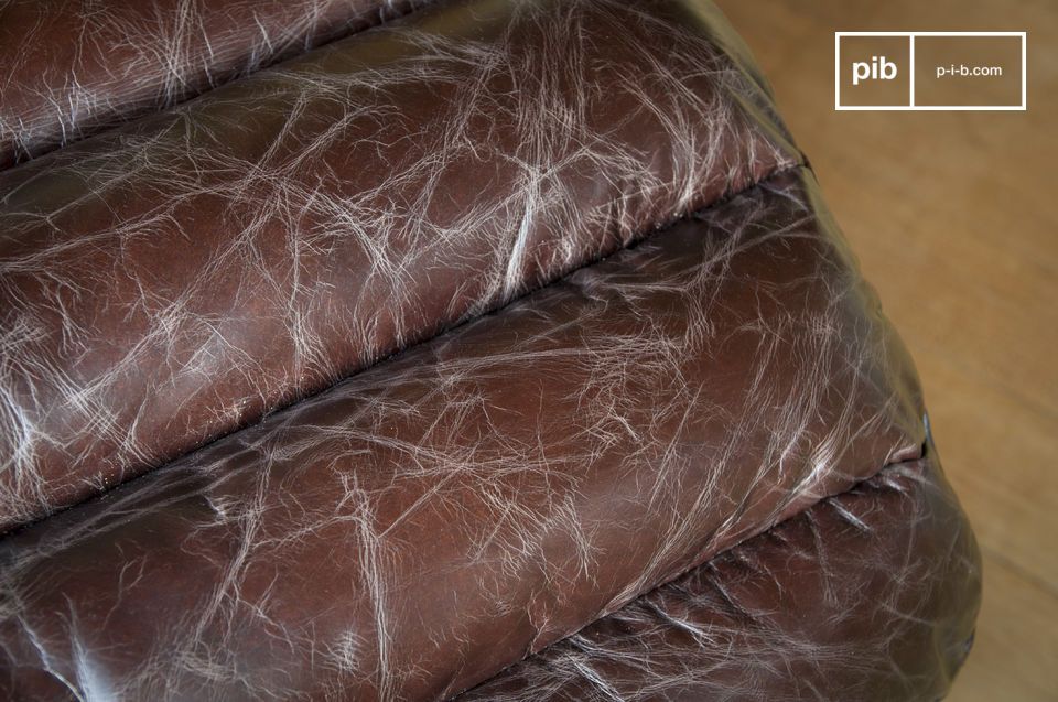 The foam mattress is covered with slightly aged leather with a brown colour that tends slightly