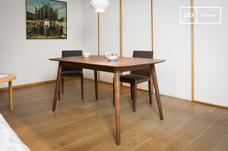 Beautiful dark wooden dining table with compass legs.