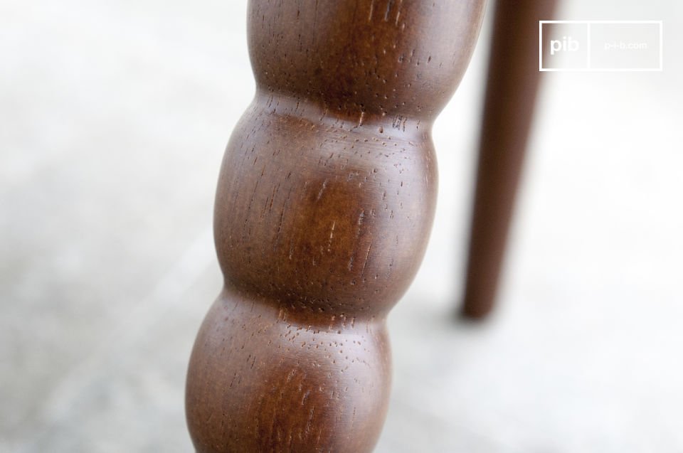One of the legs is all roundness carved in the wood.