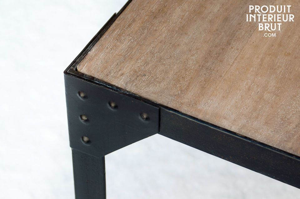 A small light wood table with a riveted mat black iron frame that makes this a sturdy piece of