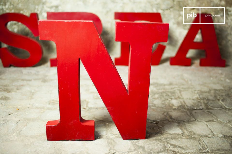 Sign letter N in patinated red metal.