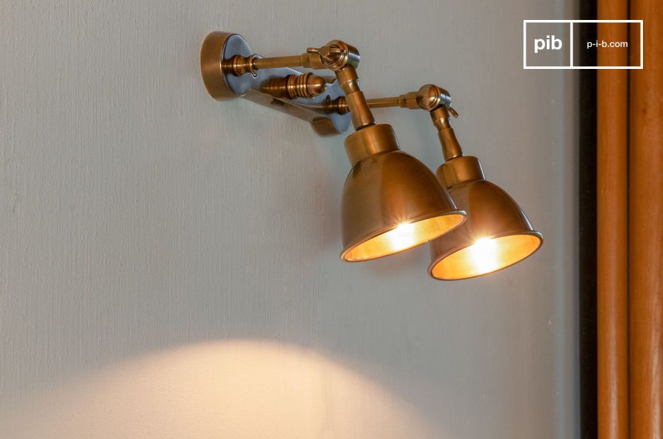 A double wall lamp in patinated brass