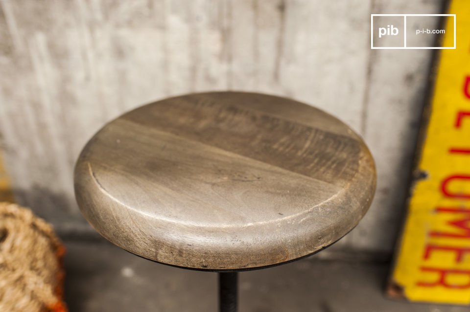 The round seat is made of wood, which tends towards grey.