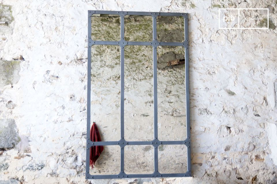 Large vintage industrial mirror in a rustic setting.