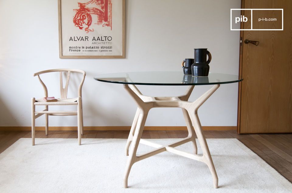 A glass table with a round top and a beautiful design.