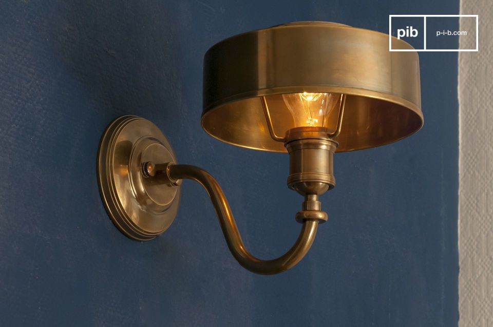 The Amber golden brass wall lamp brings a touch of warmth and a soft atmosphere to your home\'s