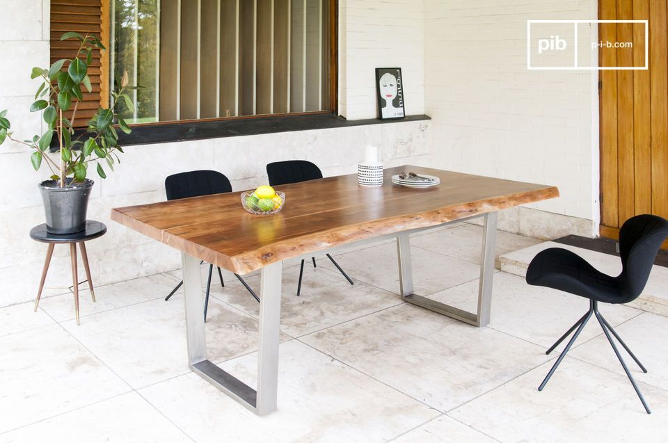 Large table in light wood with angular metal base.