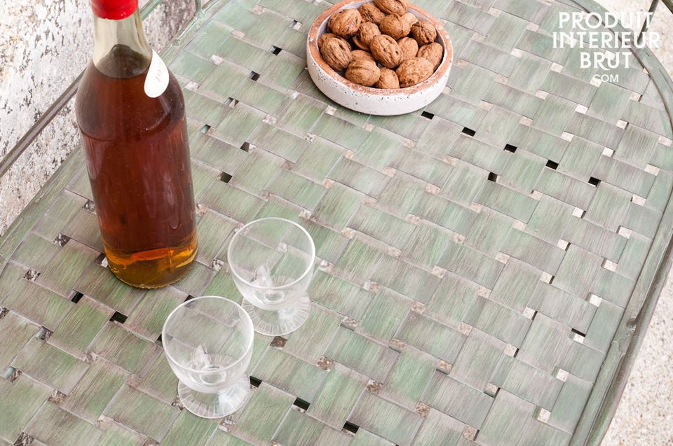 This distressed green metal table can be used indoors or outdoors