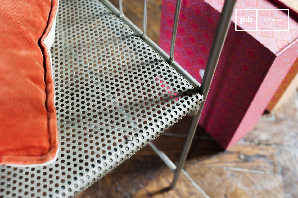 The seat of the bench is perforated with many pretty little holes.