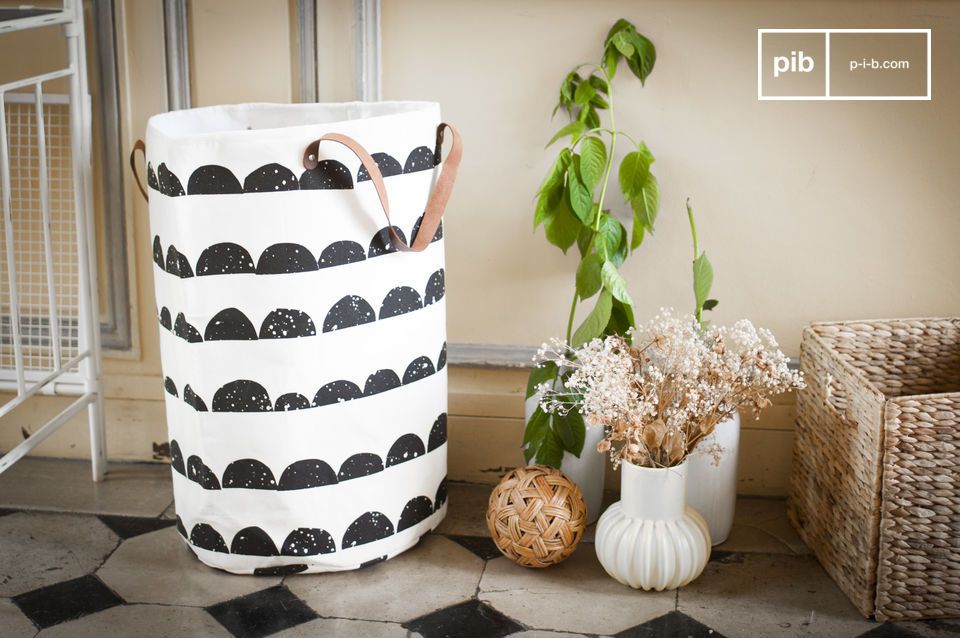 Beautiful white laundry basket with black patterns.