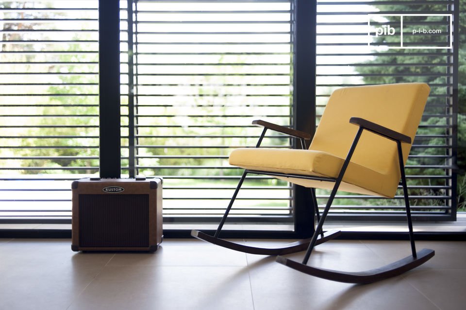 Beautiful rocking chair with yellow fabric.