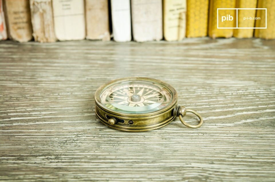 Nice compass on varnished wooden desk.