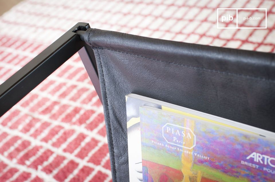 The magazine rack is made of leather in a beautiful dark colour.