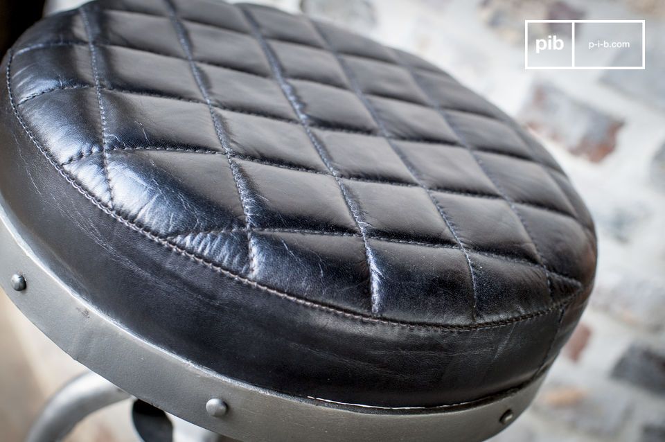 The leather seat has elegant geometric markings.