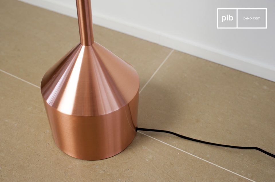 The metal floor lamp is covered with a layer of pink copper.