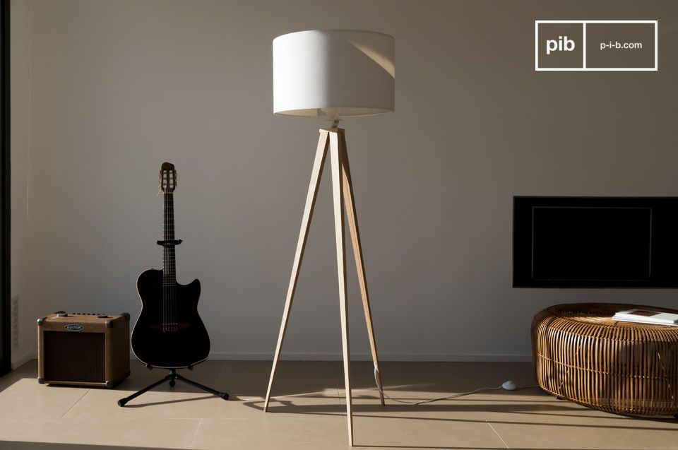 Large tripod floor lamp with white lampshade.