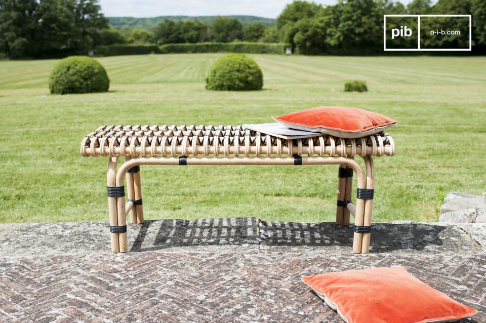 The small bench is made out of rattan material that has been assembled and braided by hand