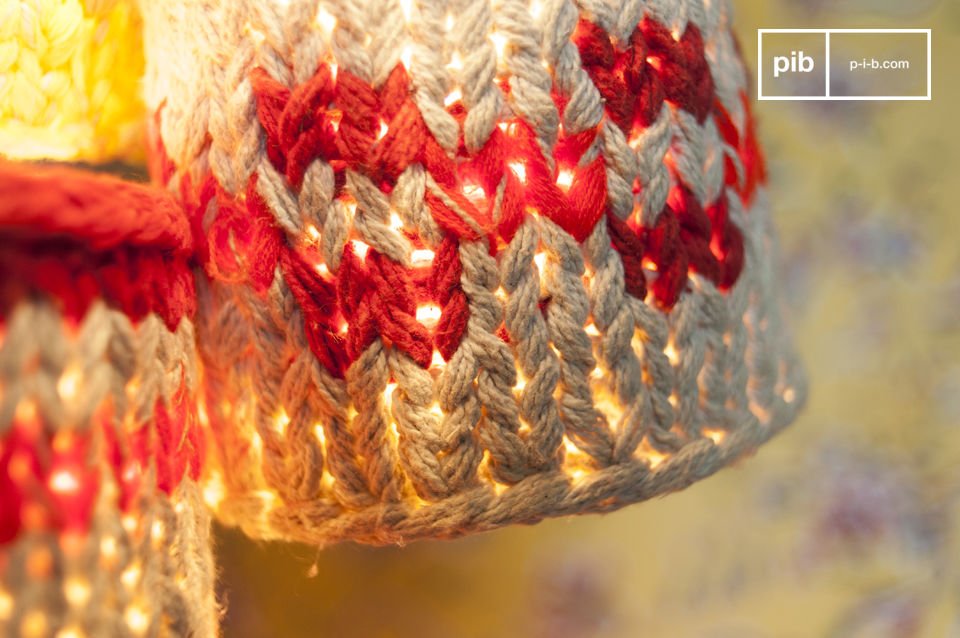 These small hanging lamps that are hung on a white thread are wrapped in knitted fabric and express