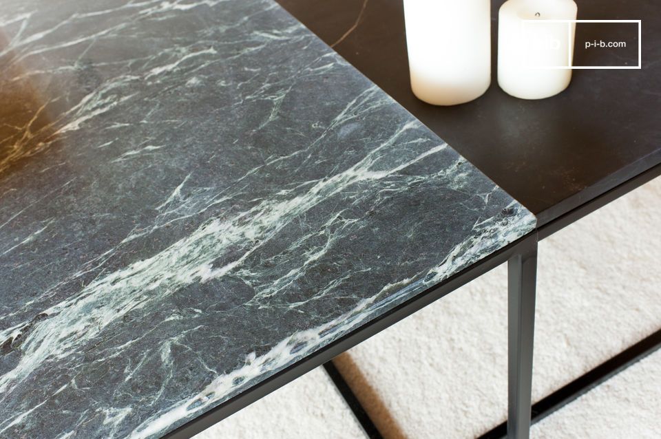 The black structure blends with the deep, ribbed green of the marble.