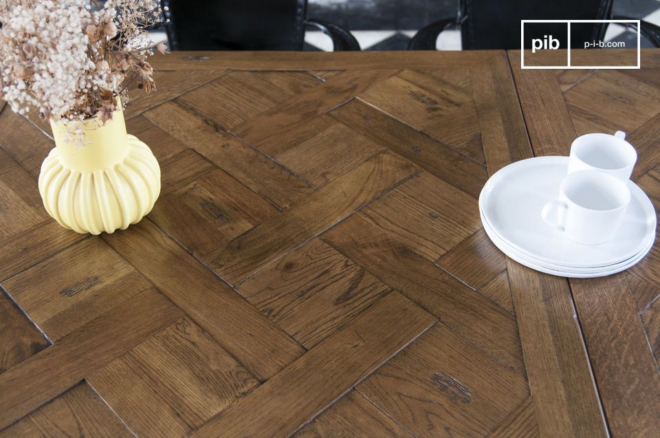 Versailles parquet flooring offers a delicate texture to the table.