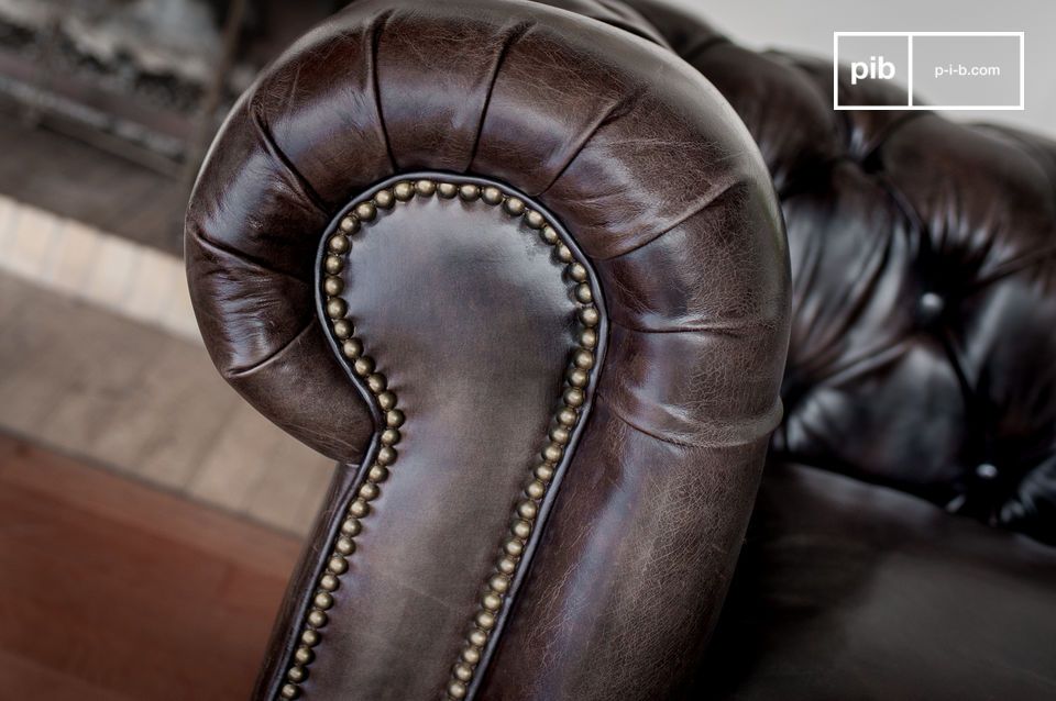 The arms of this sofa are upholstered in studded leather