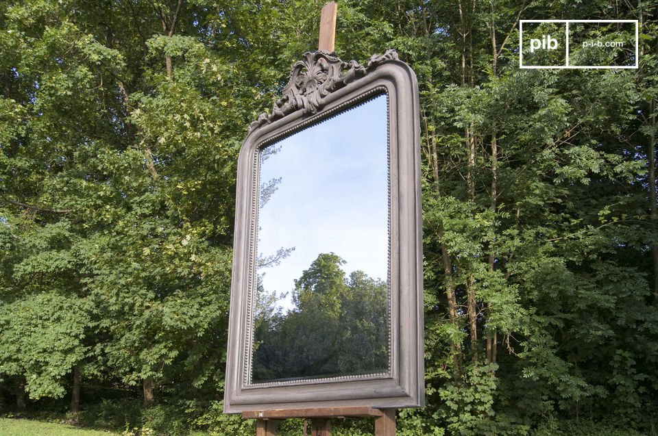 Wooden frame crowned by neat ornaments.