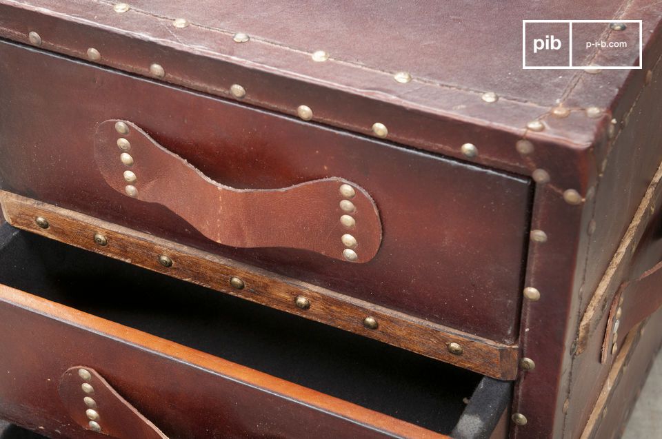 Pretty leather handles are studded on the drawers.