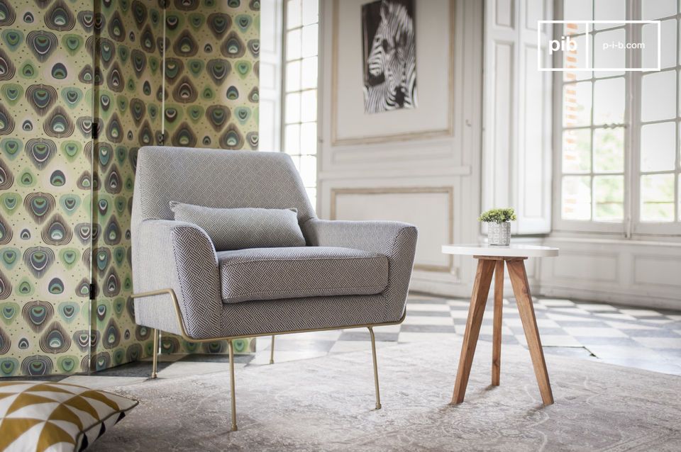 A pretty grey armchair on its very fine legs.