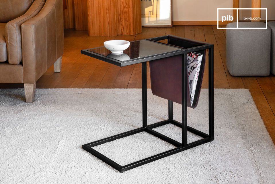 A magazine table in leather and elegant black marble.