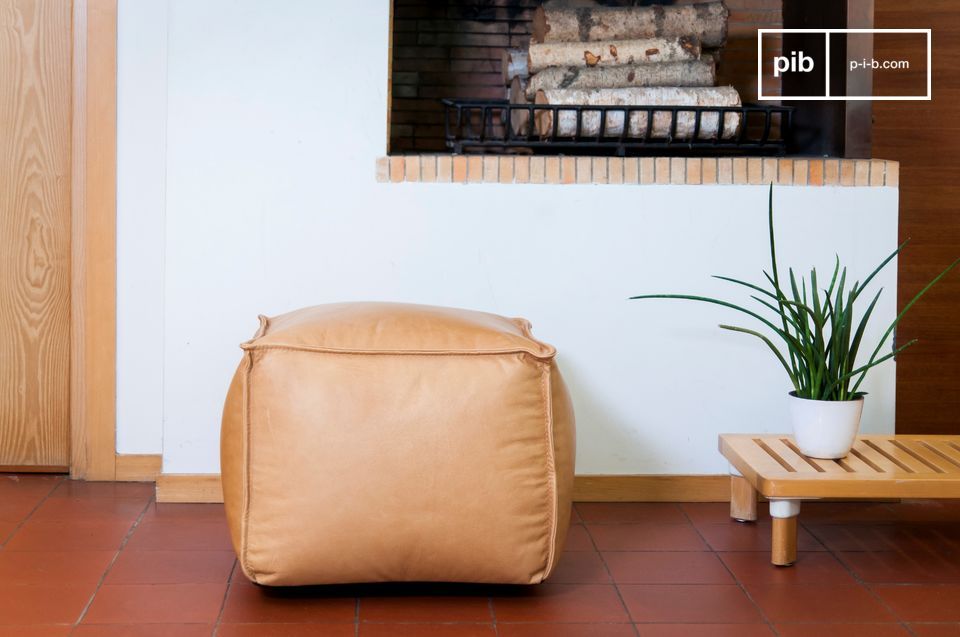 Light brown leather armchair with rounded lines.