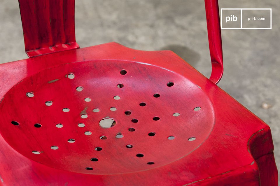 The chair has a beautiful patinated red finish.