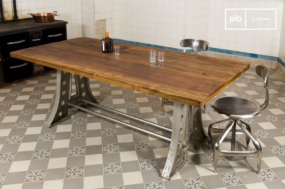 a large dining table with a characteristic industrial design.