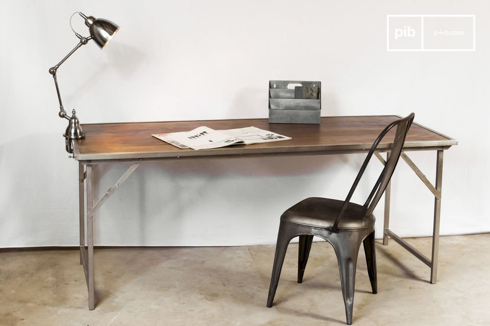 Industrial table accompanied by chair, lamp and retro objects.