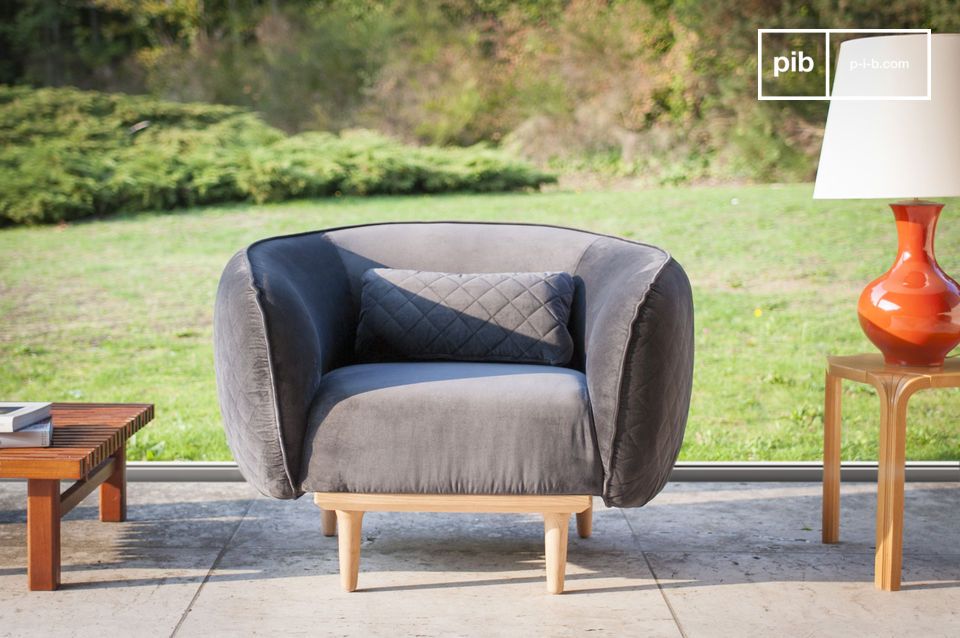 Beautiful velvet armchair with rounded shapes.