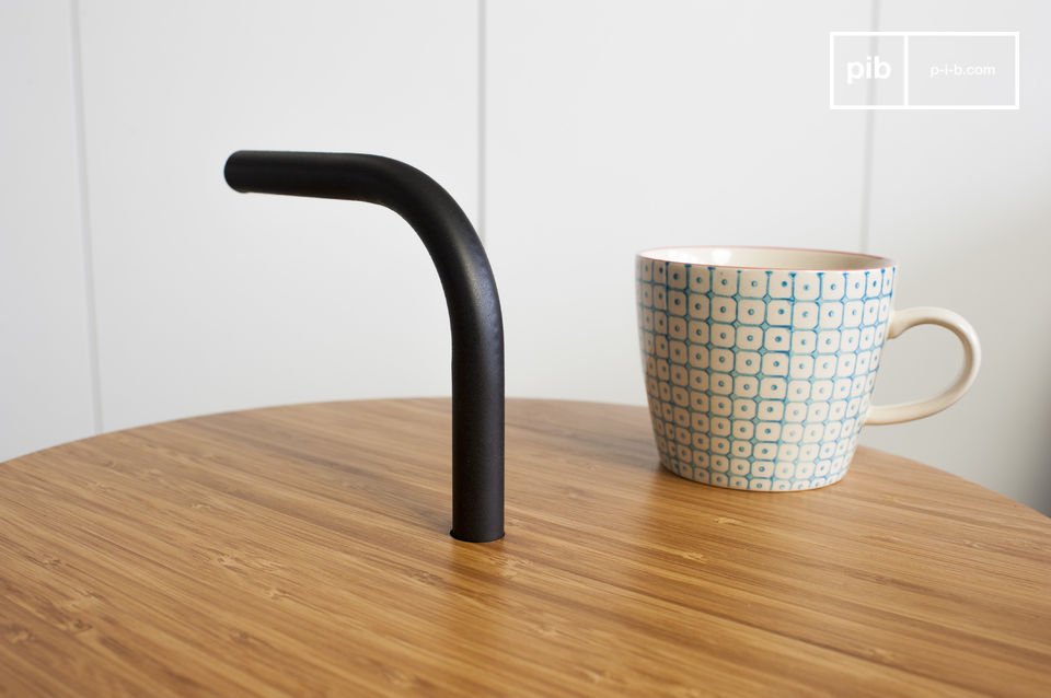 The black structure crosses the table to form a handle.