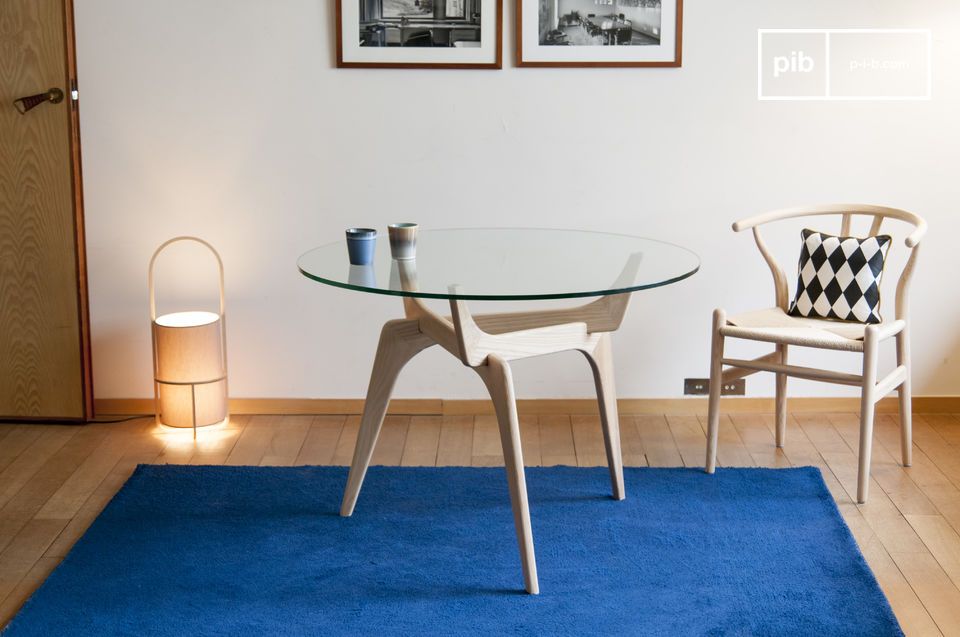 Elegant table with glass top and ash base.