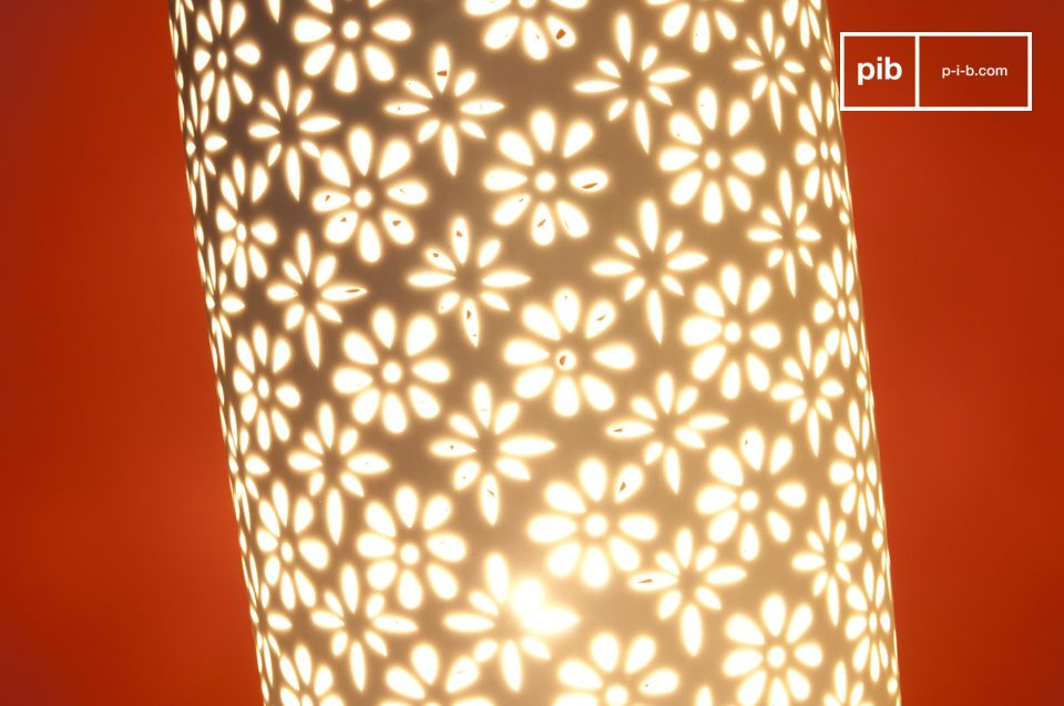 The lampshade features delicate flowers cut from ceramic.