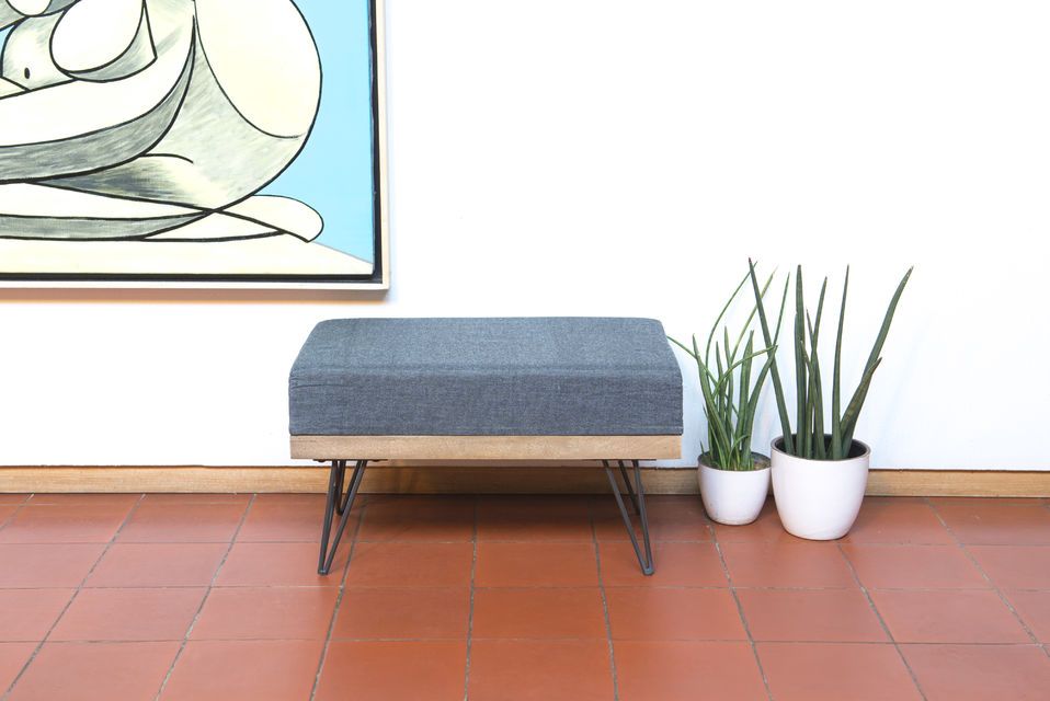 A pretty rectangular light grey pouf.