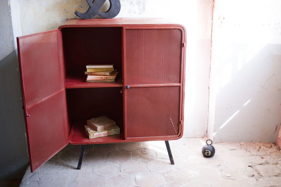 Beautiful storage space for this patinated metal cabinet.