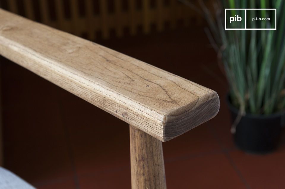 The solid wood armrest retains its organic character.