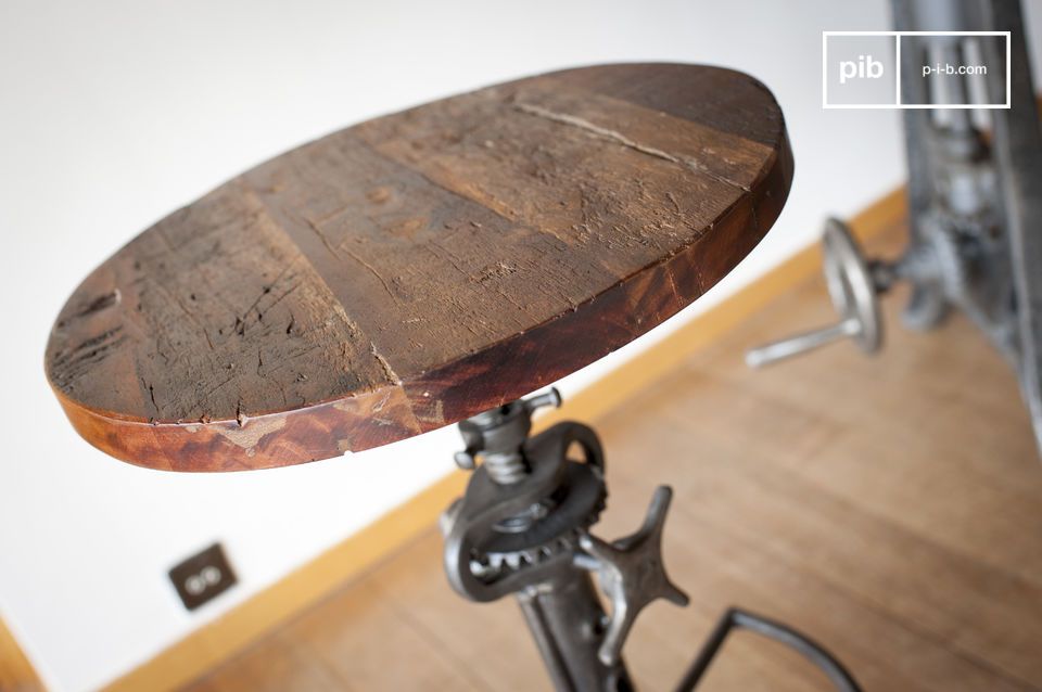 The stool has a round top made of old varnished teak.
