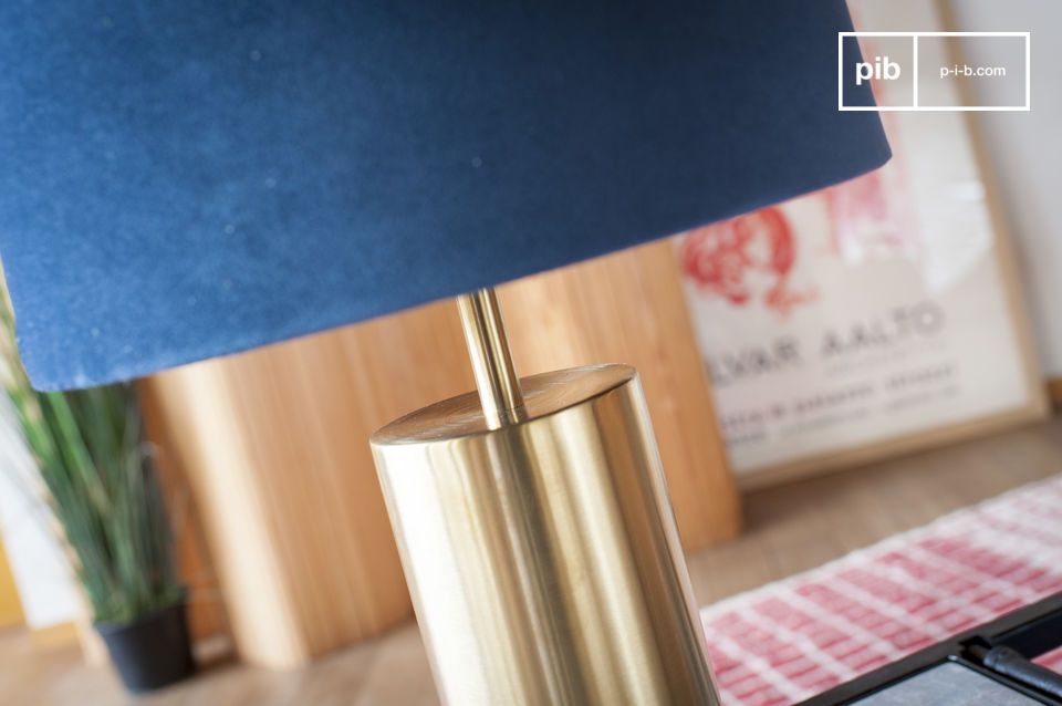 Cylindrical lamp base in brushed brass has a golden hue.